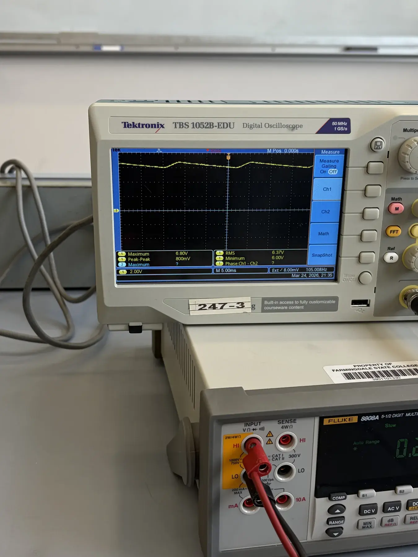 Oscilloscope displaying a mostly DC-level trace with visible repeating variation and measurement readouts